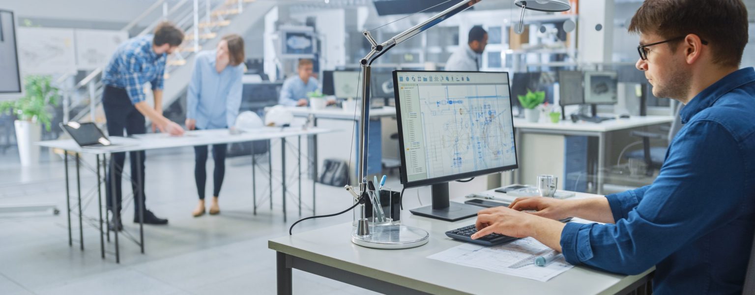 In the Busy Engineering Facility: Diverse Group of Engineers, Technicians, Working on Design for Industrial Engine Prototype. Specialists Talk During Meetings, Work with Drawings, Use Computers